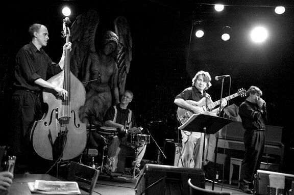 The original East Side quartet — Matt Senjem on upright bass, with guitar, drums, and Clint Hoover on harmonica